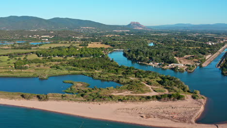 Sandy-beach-Saint-Aygulf-aerial-shot-river-Argens-joining-the-sea-France