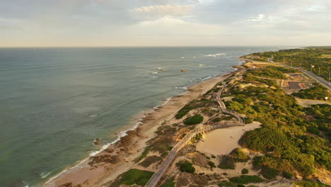 Beautiful-wooden-path-along-the-ocean-coastline-of-Port-Elizabeth-beach-aerial