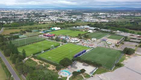 Football-fields-in-Montpellier-aerial-large-view-green-grass-soccer-fields-cloud