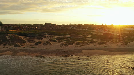 Sunset-over-the-sandy-coast-of-Port-Elizabeth-South-Africa-waves-in-the-ocean