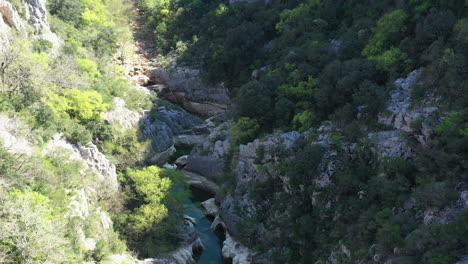 Carved-eroded-rocks-by-Herault-river-ravin-des-arcs-aerial-shot-France-sunny