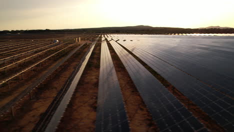 Rows-of-solar-panels-in-the-South-of-France,-capturing-the-sunset's-golden-glow