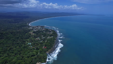 Aerial-shot-of-waves-breaking-along-the-jungle-fringed-beach-in-Puerto-Viejo.