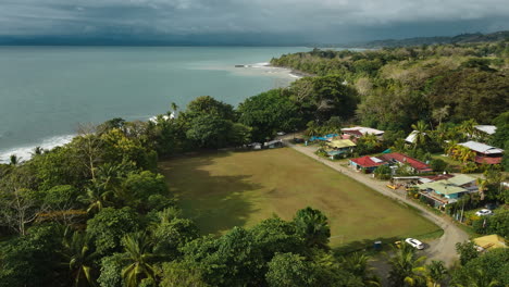 serene-aerial-view-of-a-coastal-community-in-Costa-Rica-lush-greenery-calm-sea