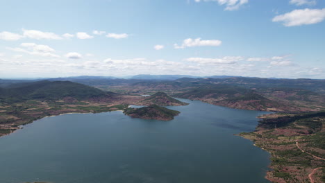 Large-aerial-shot-over-Salagou-lake-sunny-day-France-mountains-along-big-lake