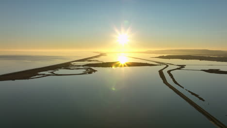 Etang-de-Vic-aerial:-sunlit-serene-waterscape.