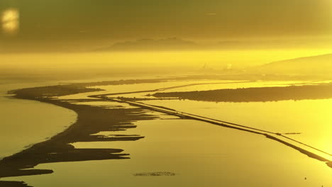 Sete-from-the-distance-aerial-golden-hour-yellow-sea-and-ponds