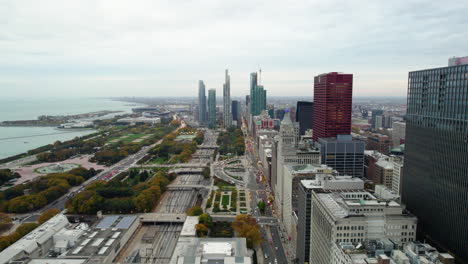 Aerial-view-flying-along-the-Michigan-Ave,-cloudy,-fall-evening-in-Chicago,-USA