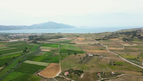 Farmland-located-near-the-sea-with-mountains-in-the-background