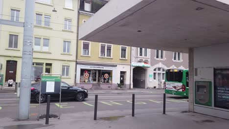 Large-Green-Bus-Stops-at-Basel-SBB-Railway-Station,-Streets-of-Switzerland-City