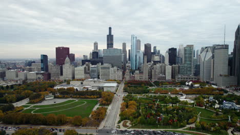 Aerial-view-of-vibrant-fall-foliage-in-the-Millennium-park,-cloudy-day-in-Chicago