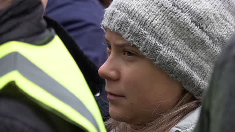 In-slow-motion-Swedish-climate-change-activist-Greta-Thunberg-is-seen-standing-in-a-crowd-of-people-during-an-Extinction-Rebellion-protest