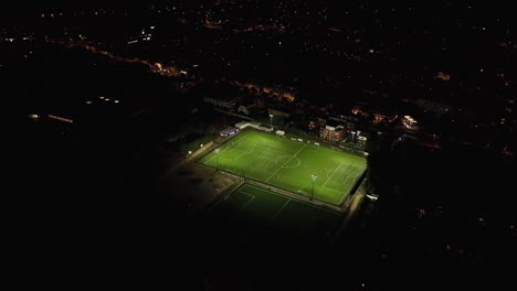 Nighttime-aerial-views-of-Montpellier,-Castelnau-le-Lez,-and-football-fields.