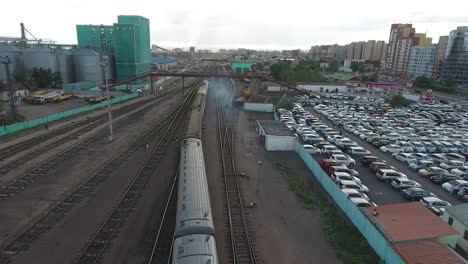 Aerial-drone-station-close-up-following-train-in-Mongolia-Ulan-Bator.-Sunny-day