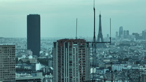 On-a-smoggy-day,-the-Eiffel-Tower-emerges-through-the-urban-haze,-a-resilient