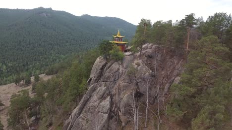 Aerial-drone-shot-flying-over-a-temple-on-rocks-in-Mongolia