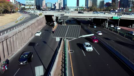 Drone-backwards-solar-panels-Mexico-city-driveway-daylight