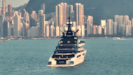 'Nord'-private-super-yacht-anchored-in-HK,-with-Hong-Kong-dense-urban-development-in-backdrop