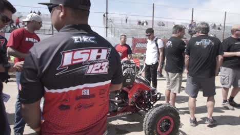 People-tuning-and-preparing-a-quad-for-a-race-in-the-desert