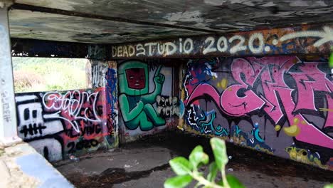 View-of-graffiti-spray-painted-WW2-bunker-in-Oruaiti,-previously-known-as-Fort-Dorset-at-Breaker-bay-in-Wellington,-New-Zealand-Aotearoa