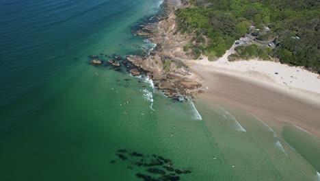 Aerial-View-Of-Surfers-At-Clarkes-Beach-In-NSW,-Australia---drone-shot