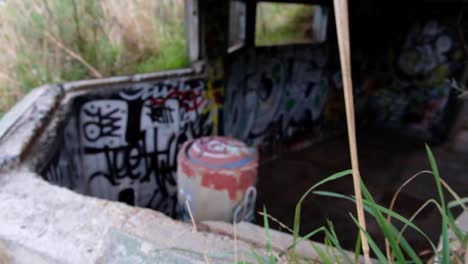 Looking-inside-a-graffiti-covered-WW2-bunker-in-Oruaiti,-previously-known-as-Fort-Dorset-at-Breaker-bay-in-Wellington,-New-Zealand-Aotearoa
