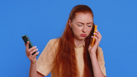 Irritated-stressed-business-woman-talking-on-two-mobile-phones-having-conversation-conflict-quarrel