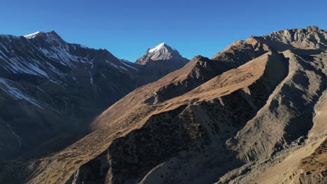 Mountain-scenery-in-nepal-highlands-with-snowy-peaks-and-ridgeline,-aerial-flying
