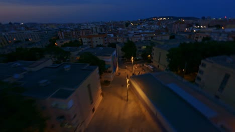 FPV-aerial-flying-over-city-apartment-buildings-at-night
