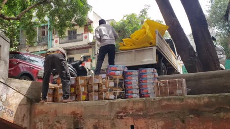 Workers-are-loading-boxes-of-cardboard-boxes-into-the-pickup-truck-from-the-seller's-shop