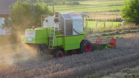 Moving-shot-of-a-harvester-working-in-the-field-on-a-sunny-day