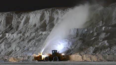 Trucking-Shot-Blower-Blasting-Winter-Snow-Two-Stories-Tall-to-Huge-Pile-Night-Jobs