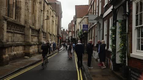 Hand-held-shot-of-tourists-walking-through-york-city-centre-on-a-overcast-day