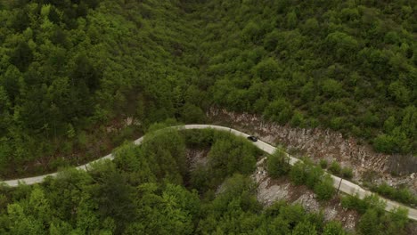 Aerial-drone-flight-over-curved-road-into-the-jungle