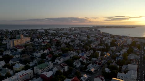 Captured-in-4K,-a-late-night-sunset-bathes-Reykjavik-in-soft-light-at-11pm,-showcasing-summer-in-Iceland-as-the-sun-dips-below-the-cityscape-in-August