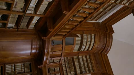 Vertical---Antique-Wooden-Bookshelves-With-Old-Volumes-Of-Books-In-Biblioteca-Teresiana-In-Mantua,-Italy