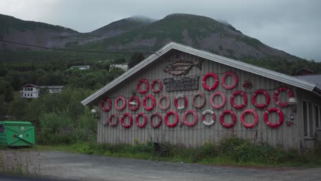 Building-Facade-With-Lifebuoys-In-Fishing-Village-Of-Torsken-In-Senja,-Norway
