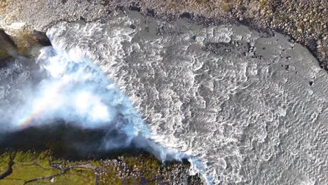 Top-down-shot-overhead-Gullfoss-waterfall-flowing-creating-a-rainbow-in-the-canyon