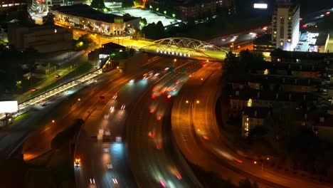 Traffic-on-multilane-freeway-and-road-bridge-spanning-thoroughfare