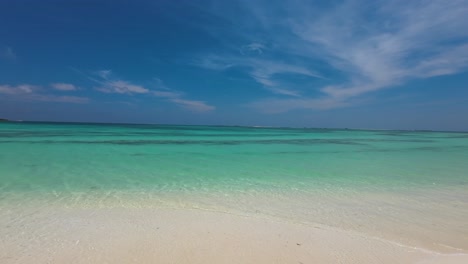 woman-beach-take-selfie-sunbath-lying-on-white-sand,-pan-left-caribbean-sea-background