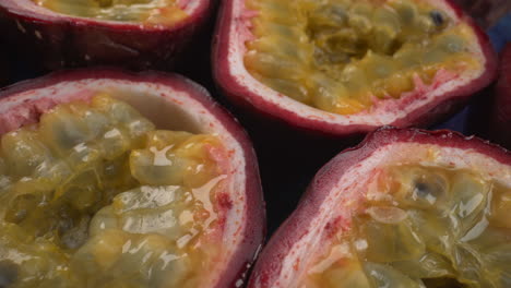 Rotating-passion-fruits-close-up,-juicy-tropical-maracuya,-exotic-fruit,-4K-macro-shot