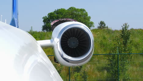 Close-up-of-landed-airplane-turbine,-testing-thrust-reversal