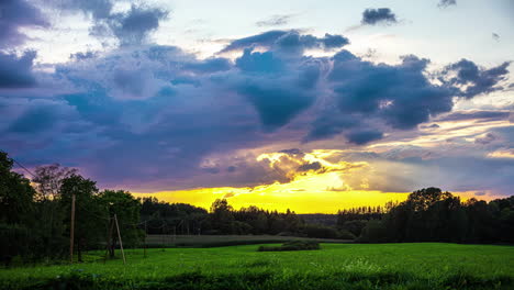 sunset-timelapse-in-green-rural-field,-meadow-moving-clouds-time-lapse