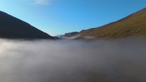 Aerial-establishing-shot-overhead-low-lying-clouds-in-an-Icelandic-valley