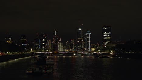 Nocturnal-shot-of-London-skyscrapers-and-Westminster-Bridge-at-night