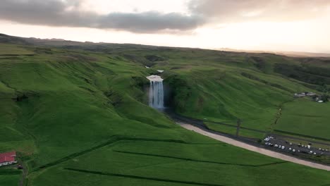 Skógafoss,-South-Iceland---A-Tranquil-View-of-Botanicals-and-Streaming-Waterfall---Aerial-Sideways