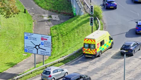 Aerial-View-Of-Ambulance-And-Cars-Driving-In-The-Road-In-Rotherham,-England