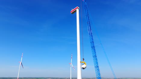 Windmill-Under-Construction-Against-Blue-Sky---drone-shot