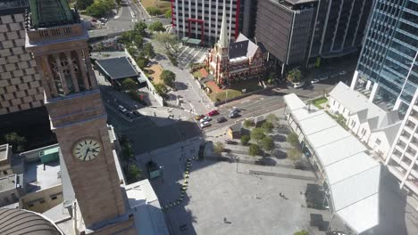 Brisbane-city-hall-clock-tower-and-church-in-downtown-district-center,-aerial-overview