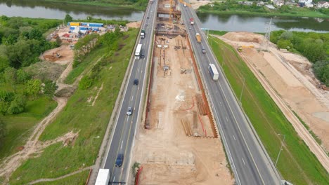 Construction-site-of-middle-bridge-of-A1-in-Kaunas-city,-fly-over-view